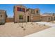 Tan two-story home with drought-resistant landscaping and a two car garage at 18365 W Villa Hermosa Ln, Surprise, AZ 85387