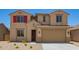 Two-story home featuring a tile roof, neutral stucco, and a two-car garage at 18365 W Villa Hermosa Ln, Surprise, AZ 85387