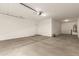 Large, well-lit garage with concrete floor, ready for vehicles and storage at 18365 W Villa Hermosa Ln, Surprise, AZ 85387
