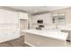 Bright, spacious kitchen with white cabinets, quartz countertops, and stainless steel appliances at 18365 W Villa Hermosa Ln, Surprise, AZ 85387