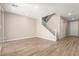Open-concept living room features wood-look tile floors and a staircase at 18365 W Villa Hermosa Ln, Surprise, AZ 85387