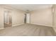 Carpeted primary bedroom featuring a walk-in closet and ensuite bathroom at 18365 W Villa Hermosa Ln, Surprise, AZ 85387