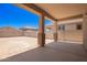Covered patio overlooking a large, private backyard with block fence and clear blue skies at 18365 W Villa Hermosa Ln, Surprise, AZ 85387