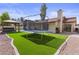 Expansive backyard with putting green, hot tub under pergola, trampoline, and artificial turf at 190 E Tremaine Ave, Gilbert, AZ 85234