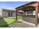 Backyard showcasing a pergola-covered hot tub, putting green, artificial turf, and trampoline at 190 E Tremaine Ave, Gilbert, AZ 85234