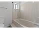 Bright bathroom with a deep tub and a window providing natural light at 190 E Tremaine Ave, Gilbert, AZ 85234