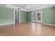 A spacious bedroom with wood floors, tray ceilings, and access to the backyard at 190 E Tremaine Ave, Gilbert, AZ 85234
