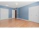 Blue-walled bedroom features three closets, wood floors, and a neutral color scheme at 190 E Tremaine Ave, Gilbert, AZ 85234