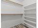 A walk-in closet with ample storage shelves and hanging rods for organized living at 190 E Tremaine Ave, Gilbert, AZ 85234