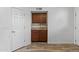 A portion of the kitchen showcasing cabinets, countertops, and access to a door at 190 E Tremaine Ave, Gilbert, AZ 85234