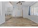 Open-concept living room with exposed beams, ceiling fan, and beautiful wood-look tile flooring at 190 E Tremaine Ave, Gilbert, AZ 85234