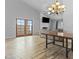 Spacious living room with fireplace, ceiling fan, and beautiful wood-look tile flooring at 190 E Tremaine Ave, Gilbert, AZ 85234