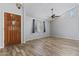 Bright living room with ceiling fan, large window, and beautiful wood-look tile flooring at 190 E Tremaine Ave, Gilbert, AZ 85234