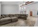Open-concept living room with exposed beams, ceiling fan, and beautiful wood-look tile flooring at 190 E Tremaine Ave, Gilbert, AZ 85234