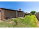 Enclosed backyard with a patio cover, grill and lush green grass, perfect for entertaining and relaxation at 2059 E Brown Rd # 35, Mesa, AZ 85213