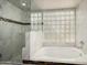 Luxurious bathroom boasts a separate glass enclosed shower and tub with tile surround at 2059 E Brown Rd # 35, Mesa, AZ 85213
