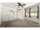 Bedroom features neutral carpet, paint, ceiling fan and a window at 2059 E Brown Rd # 35, Mesa, AZ 85213