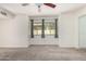 Bedroom featuring neutral carpet, paint, a ceiling fan, and a large window at 2059 E Brown Rd # 35, Mesa, AZ 85213