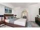 Spacious bedroom with a platform bed, modern lighting, and large windows with natural light at 2059 E Brown Rd # 35, Mesa, AZ 85213