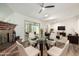 Open-concept dining area featuring a glass table, a fireplace, and an adjacent living space at 2059 E Brown Rd # 35, Mesa, AZ 85213