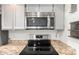 Kitchen features stainless steel microwave above stove and speckled countertop at 2059 E Brown Rd # 35, Mesa, AZ 85213