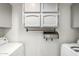 Bright laundry room featuring cabinet storage and laundry equipment at 2059 E Brown Rd # 35, Mesa, AZ 85213