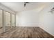 Empty room featuring wood-look flooring and sliding glass doors to the outside at 2059 E Brown Rd # 35, Mesa, AZ 85213