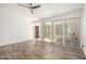 Empty room featuring wood-look flooring, ceiling fan and access to front door at 2059 E Brown Rd # 35, Mesa, AZ 85213