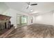 Spacious living room featuring wood-look flooring, vaulted ceiling and sliding glass doors to back yard at 2059 E Brown Rd # 35, Mesa, AZ 85213