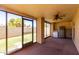 Enclosed patio with ceiling fan and large windows looking out into the backyard at 2059 E Brown Rd # 35, Mesa, AZ 85213