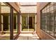 Enclosed patio space with brick flooring, glass block window and glass sliding doors to interior at 2059 E Brown Rd # 35, Mesa, AZ 85213