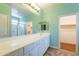 Bathroom with extra long white vanity, large mirror and tile floors and private rooms at 22993 W Micah Way, Buckeye, AZ 85326