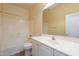 Bright bathroom with white cabinets, tile floors, and ample lighting at 22993 W Micah Way, Buckeye, AZ 85326