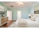 Serene bedroom with wood floors, neutral decor, and a view to the ensuite bathroom at 22993 W Micah Way, Buckeye, AZ 85326