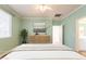 Bedroom with light green walls, wood floors, recessed lighting, and ample natural light at 22993 W Micah Way, Buckeye, AZ 85326