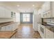 Spacious kitchen with tile floors, white appliances, white cabinets and attached eating area at 22993 W Micah Way, Buckeye, AZ 85326