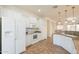 Well-equipped kitchen with tile floors, white appliances, white cabinets and granite counters at 22993 W Micah Way, Buckeye, AZ 85326