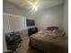 Relaxing bedroom featuring ceiling fan, large window, plush carpet and desk area at 2311 E Hartford Ave # 38, Phoenix, AZ 85022