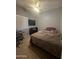 Neutral bedroom with a ceiling fan, large window, plush carpet and desk area at 2311 E Hartford Ave # 38, Phoenix, AZ 85022
