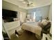 Bright bedroom featuring plush carpet, ceiling fan, walk in closet, and ensuite desk at 2311 E Hartford Ave # 38, Phoenix, AZ 85022