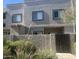 Modern two-story condo with manicured landscaping, secure gated entrance, and neutral stucco exterior at 2311 E Hartford Ave # 38, Phoenix, AZ 85022