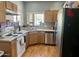 A functional kitchen includes wood cabinets, white appliances, and stainless steel dishwasher and sink at 2311 E Hartford Ave # 38, Phoenix, AZ 85022