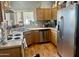 This well-lit kitchen features white and stainless steel appliances and wood cabinets at 2311 E Hartford Ave # 38, Phoenix, AZ 85022