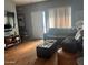 A cozy living room features a sofa, ottoman, and wood floors at 2311 E Hartford Ave # 38, Phoenix, AZ 85022