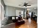 The spacious living room features wood flooring and a ceiling fan at 2311 E Hartford Ave # 38, Phoenix, AZ 85022