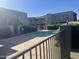 Community pool featuring a well-maintained sun deck, safety fence, and mature landscaping for resident enjoyment at 2311 E Hartford Ave # 38, Phoenix, AZ 85022