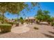 Spacious backyard with stone walkway, desert landscaping, and pool in the background at 2409 S Chestnut Pl, Chandler, AZ 85286