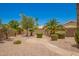 View of a well-kept backyard featuring mature landscaping, gravel ground cover and a stone walkway at 2409 S Chestnut Pl, Chandler, AZ 85286