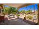 Back patio with a grill and seating area, surrounded by lush greenery and landscaping at 2409 S Chestnut Pl, Chandler, AZ 85286