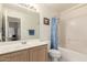 Bathroom featuring a sink, toilet, and shower with blue patterned curtain at 2409 S Chestnut Pl, Chandler, AZ 85286